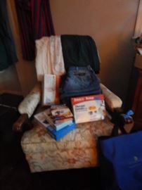 Antique chair. Pile of blue jeans, back relief medical supplies.