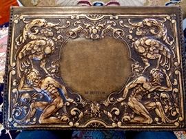 Antique, heavily embossed desk blotter - love the men in the lower corners?