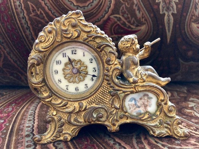Antique clock, Waterbury Clock Co with porcelain face and hand painted accents. Little cherub atop!