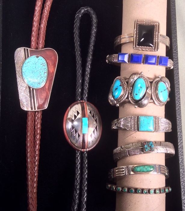 Navajo bolos by Tsosie & Mary Taylor (signed TM Taylor), Navajo sterling bracelets: with black stone by Roger Skeet, Jennifer Curtis signed bracelet with lapis, bracelet with 3 turquoise stones, unmarked stamped bracelet with square turquoise stone, feather design bracelet with intarsia stone, stamped bracelet with oval turquoise by Norman Bia, unmarked narrow bracelet with small turquoise stones