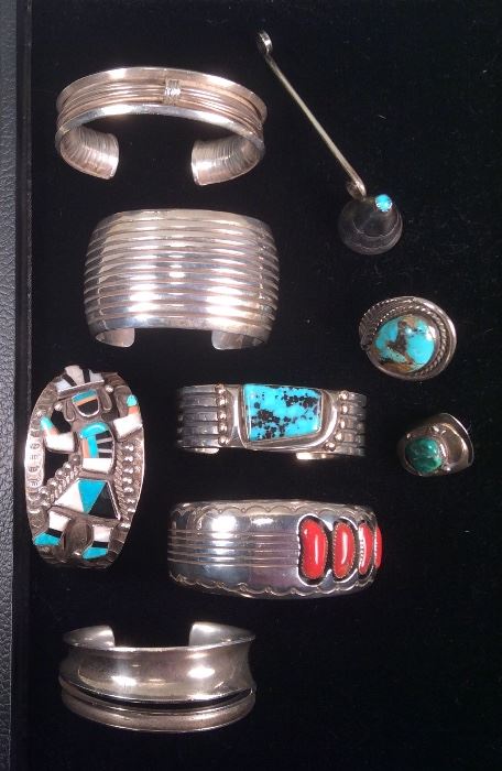 Navajo sterling jewelry - top to bottom: Signed Cheyenne Harris bracelet, candle snuffer with turquoise stone on top, signed wide cuff with channels by Darrell Slim, Zuni Kachina bracelet, signed Orville Tsinnie bracelet with dots, channels & turquoise, unmarked turquoise ring (NOTE: lower ring is not available - owner decided to keep it), signed Dan Jackson bracelet with coral, unidentified sterling bracelet with slit 