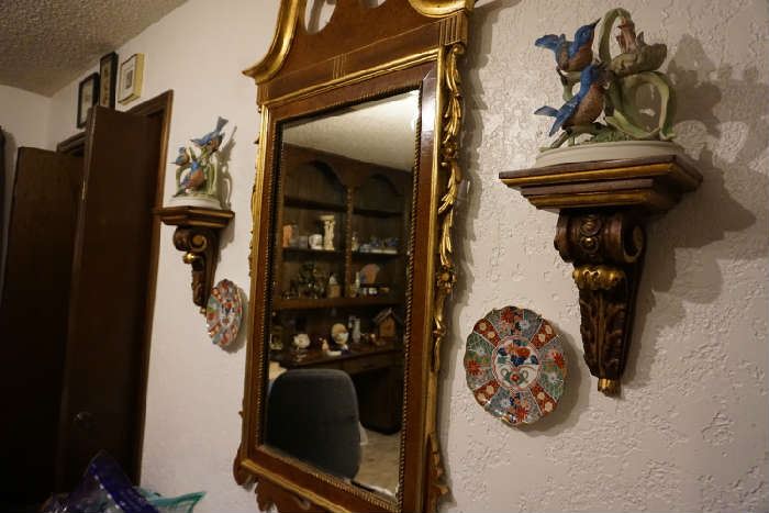 mirror, wall sconces, bird figurines