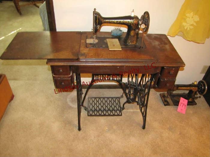 Antique Singer sewing machine serial #G0069057 w/ treadle , cabinet & book