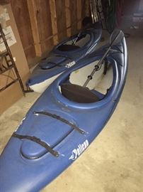 Two Pelican kayaks with paddles