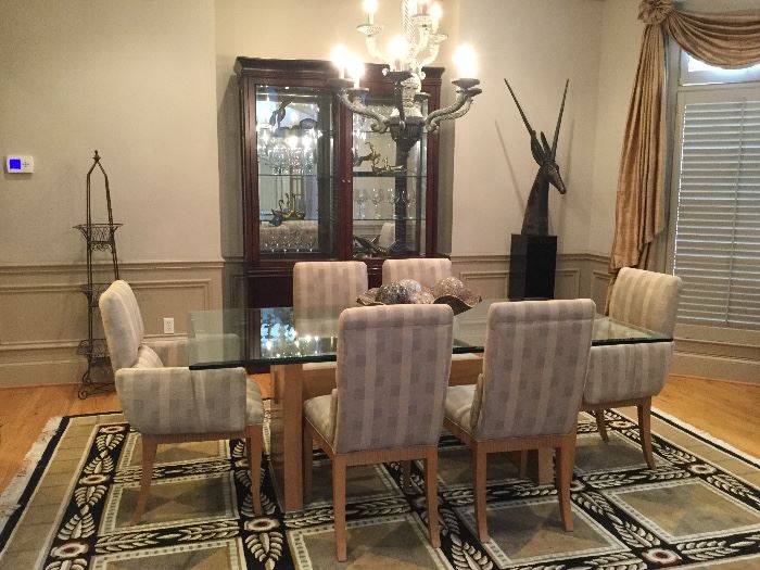 Contemporary, glass top dining table with two captains chairs, six dining chairs. 