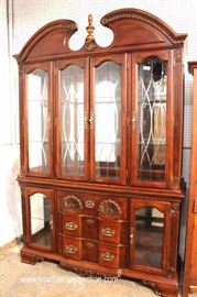Contemporary Mahogany Shell Carved 2 Piece Broken Arch China Cabinet with Curio Base by “Kathy Ireland Home”
Located Inside – Auction Estimate $100-$300