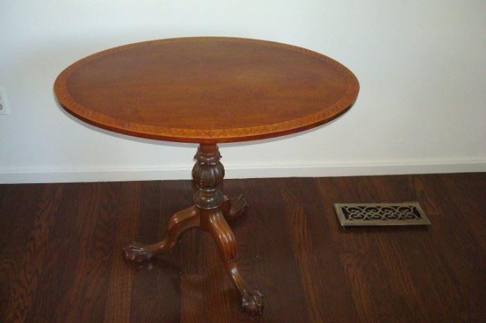 Vintage inlaid tilt top table with claw feet.