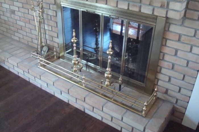 Brass fireplace tools and fender.