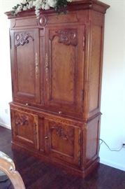 Oak breakfront/cupboard with hand carved accents and pull out writing shelf.
