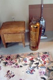 Antique wood toilet and copper fire extinguisher.