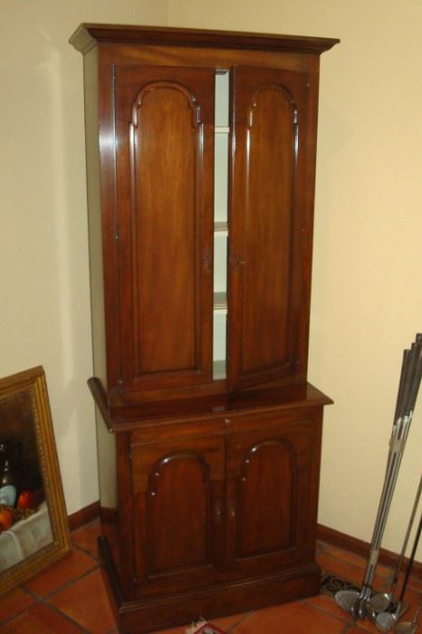 Solid cherry china cupboard with grooved plate shelves.