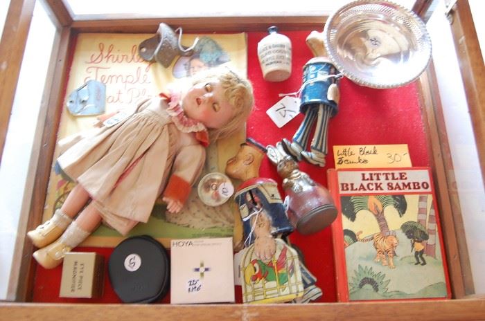 Showcase at check out table is full of treasures, Tin Wind Up Toy Popeye, Original Shirley Temple w clothes and booklet, 2 different advertising Cocal Cola openers ( 1 I have never seen), Little Black Sambo 1937, Sterling, Advertising Whiskey Jug