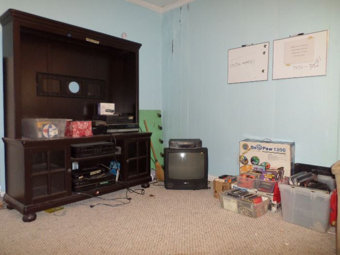 large entertainment center, stereo turntable, VCR's, small TV, CD's, DVD's