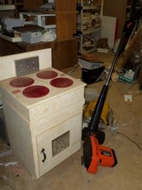 vintage child's toy electric oven & a brand new weed whacker