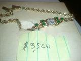 14 KT Gold Bracelet set with .30 ct Diamond soliatire surrounded by 4 small .07 ct diamonds Overal 1/2 ct total weight diamonds. Also set
with 6 emeralds .05 points each total weight .30 ct total weight