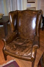 One of a pair, leather wing chairs