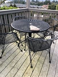 One of several sets of Woodard wrought iron outdoor furniture