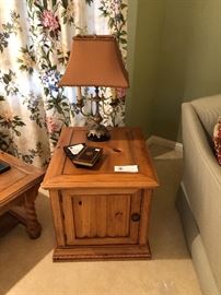 Side table shown with metal and marble lamp 