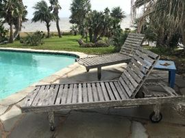 Teak poolside lounge chairs