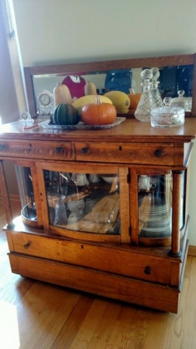 Beautiful unusual and hard to find antique buffet with curved glass.