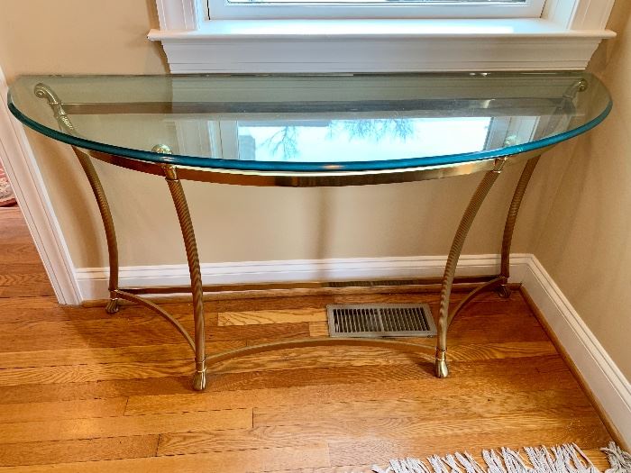 Glass top console with brass legs