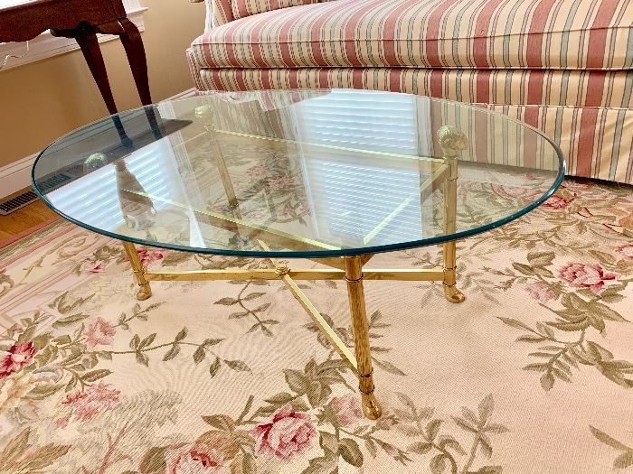 Glass top/brass coffee table with Ram's Head brass supports!