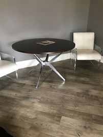 Restoratian 48” table and lucite chairs two available. 