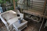 wicker settee, wicker table, two wicker chairs (shown in other photo), oriental porcelain planter, A-frame swing
