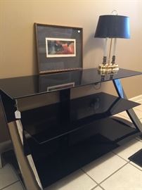 Modern smokey glass TV stand.