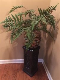 Concrete pedestal and fern.