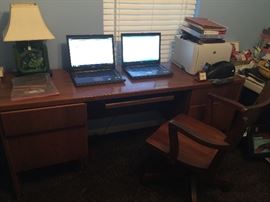 Executive desk and wooden rolling chair.