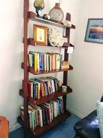 Leaning bookshelf, books