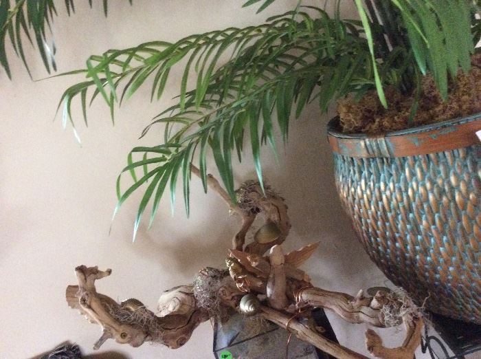 Driftwood sculpture with brass adornments
