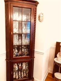 1 of a pair of corner cabinets both filled with bells collection