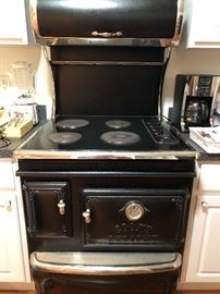 Elmira Stove Works "Cooks Delight" cast iron electric stove  with built in fan and the light. 30.5 inches wide, 29 inches deep and 64 inches tall.