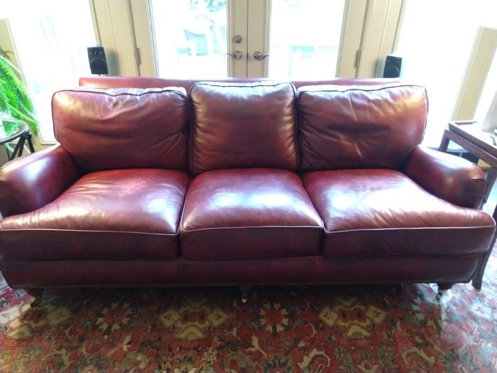 Yummy oxblood leather sofa, with aged bronze nail heads, by Hancock & Moore.                                                  
We've all seen that flaky leather crap that cheap retailers promote on sale - this is the real deal!