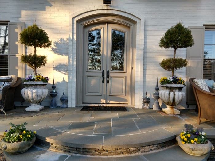 Front entry, with vintage zinc lightning rods, pair of concrete planters, with lion heads and pansies.