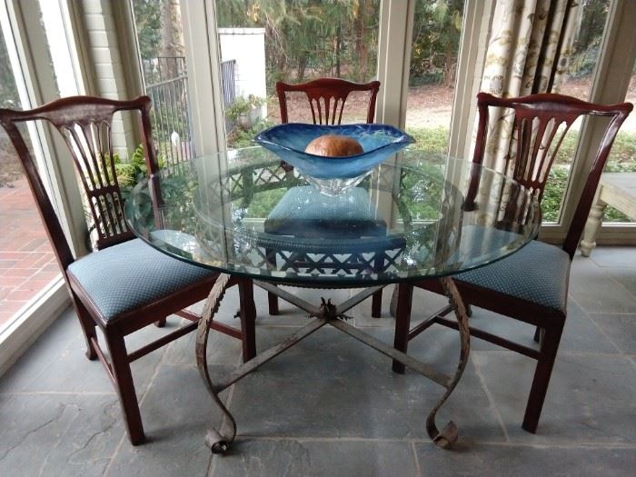 Very sturdy wrought iron/beveled glass dining table, with set of four vintage mahogany side chairs.