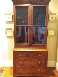 Primitive American pine cabinet, with wavy glass doors and three drawers. 