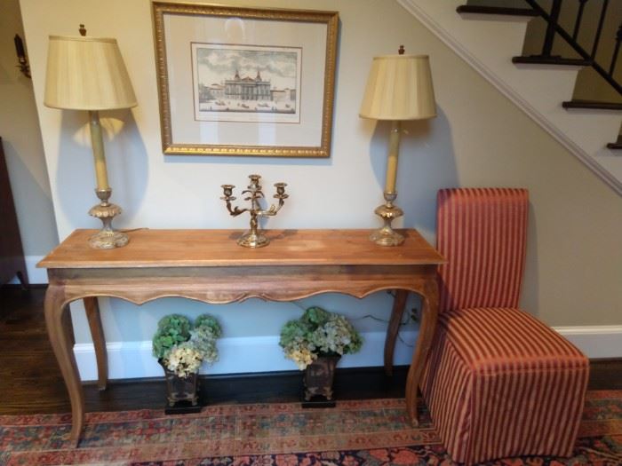 Entry hall console table, with pair of candlestick lamps, French 3-light brass candelabra and silk upholstered side chair.