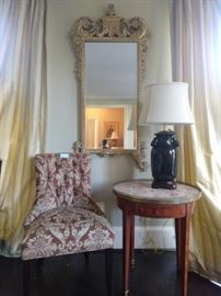 Nicely upholstered side chair, vintage bouillotte table, Asian porcelain table lamp and John Richard wall mirror.