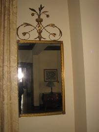Gilt mirror with ornate finial