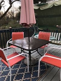 Assorted outdoor furniture--square table with umbrella and 4 chairs.