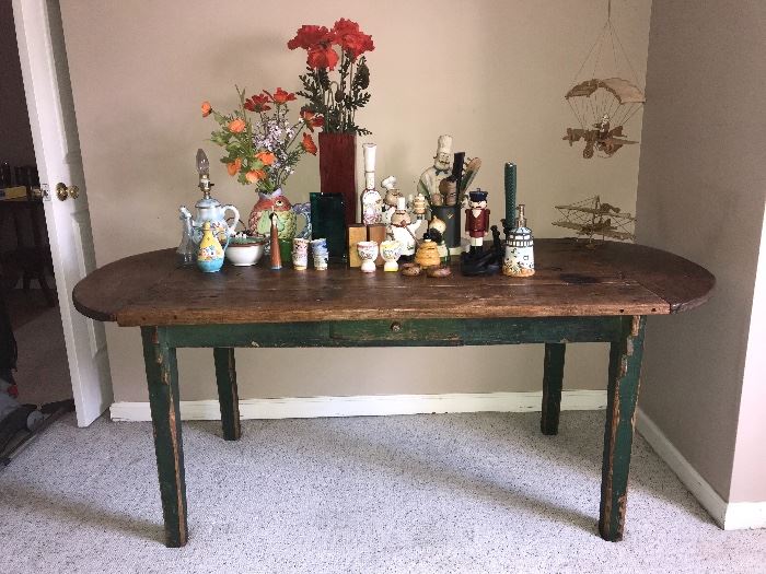 Antique country oak table with green painted legs and base, natural top. Has lots of character--deep burn mark and carved names.