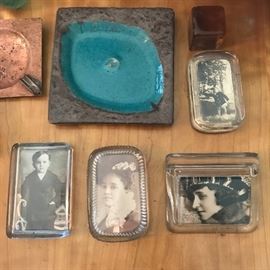 Assorted heavy glass paperweights with photos.