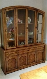 Triple China Cabinet with lights in each section, has three shelves and glass doors and storage in the bottom