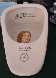 Mystery piece. Made by Boots Chemical Co. in the 19th. century. The mystery is what is Anne Bronte's painted portrait doing painted on a bed pan?  She was a famous author and this is a bed pan.
