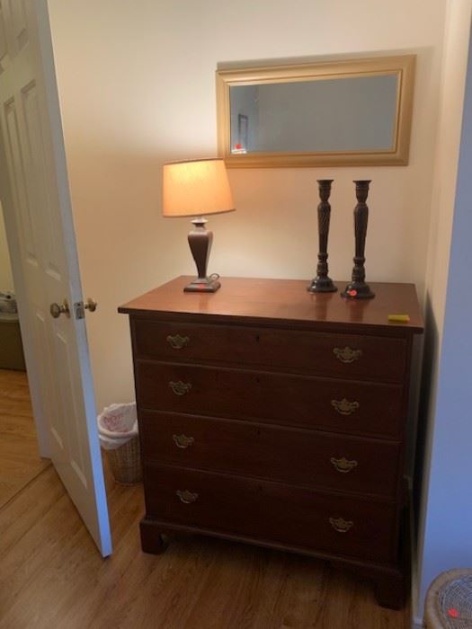 Chest of drawers, lamp, candlesticks, mirror