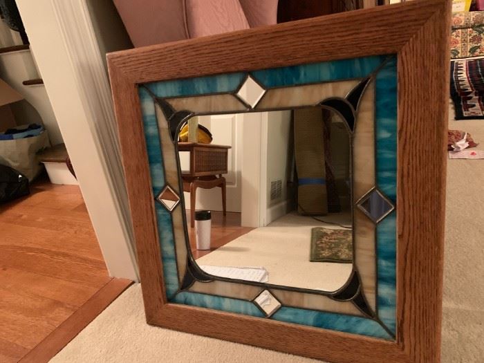 Framed mirror, surrounded in stained glass and solid wood outer edge.