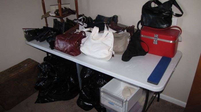 Table full of vintage purses.